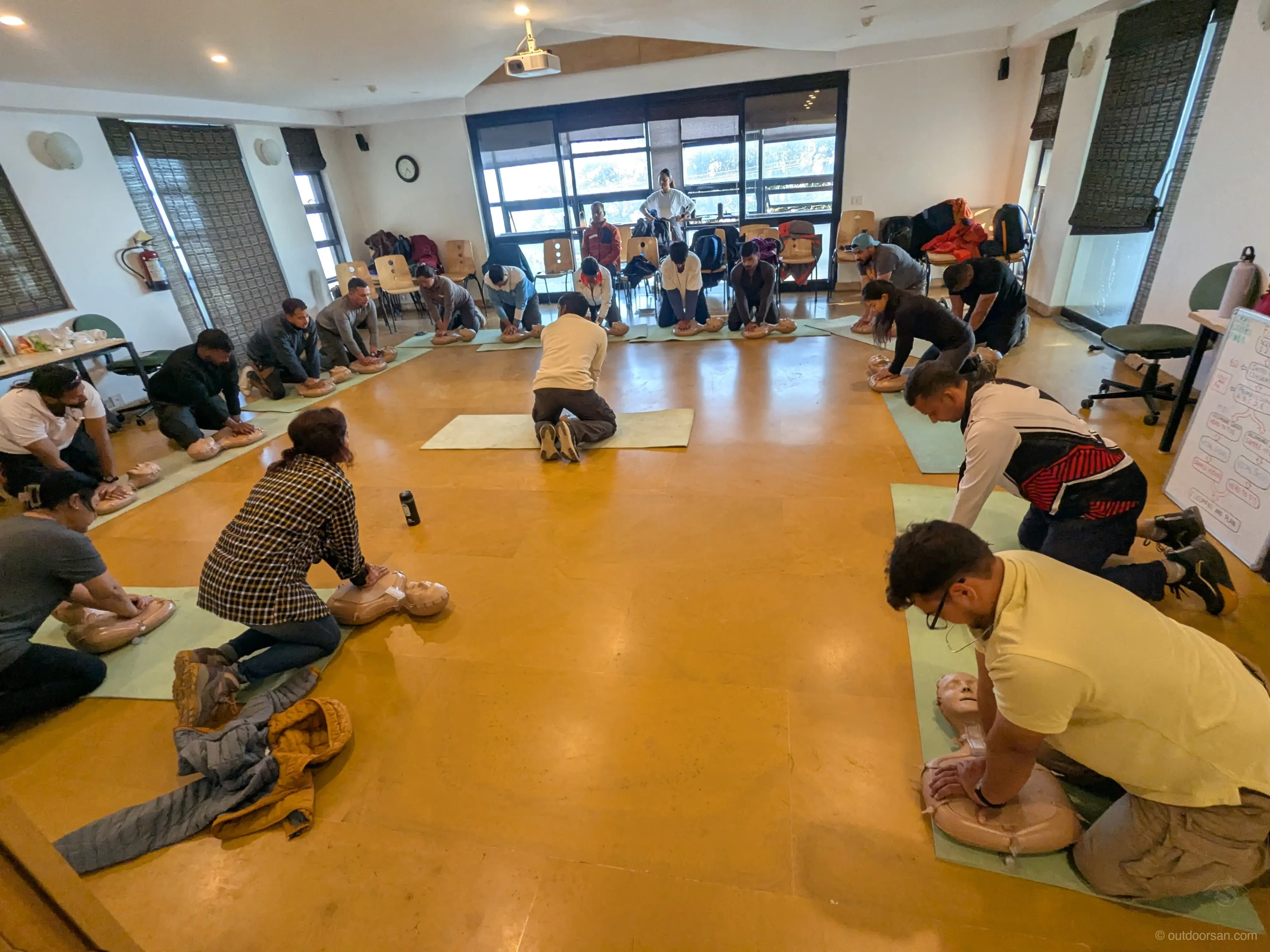Practising CPR during a wilderness first aid course on dummies