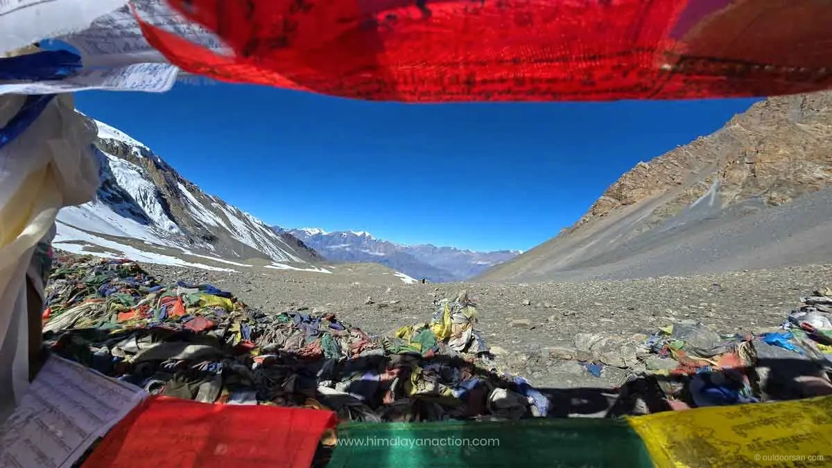 High-altitude pass crossing with prayer flags in the Nar Phu region